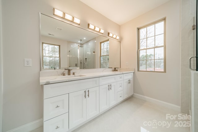 bathroom featuring vanity and a shower with door