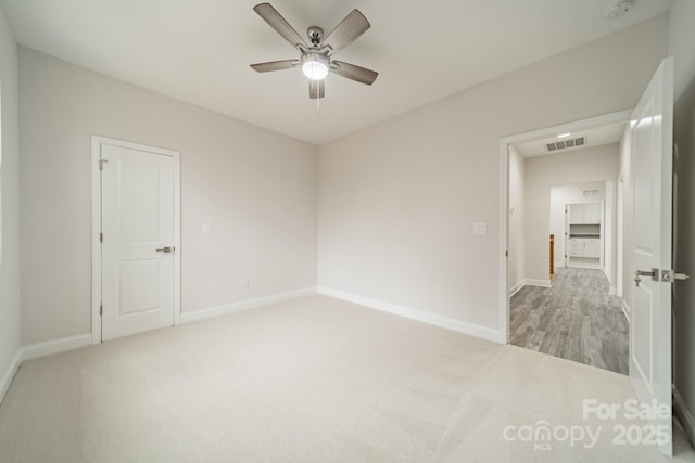 spare room with light carpet and ceiling fan