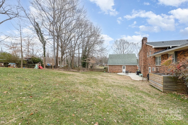 view of yard featuring a playground and a patio