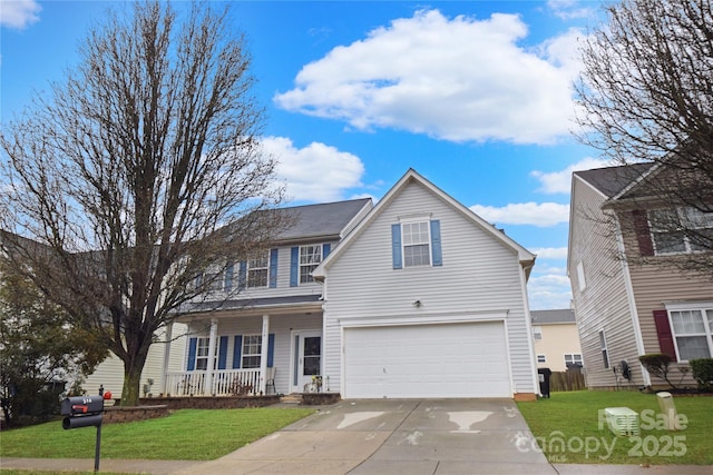 view of front of property with a porch, a garage, and a front lawn