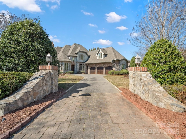 view of front of house with stone siding and concrete driveway