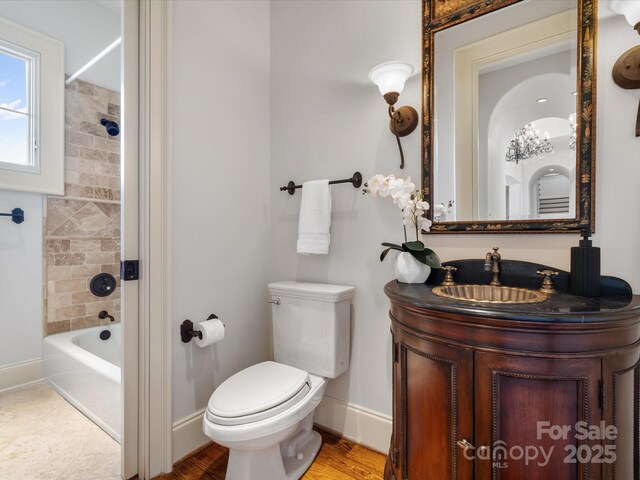 bathroom featuring shower / bathtub combination, vanity, toilet, and baseboards