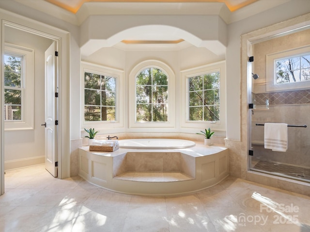 bathroom with a stall shower and a bath