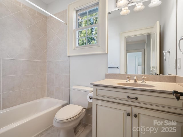 full bath with shower / bathing tub combination, tile patterned flooring, vanity, and toilet