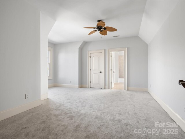 additional living space featuring a ceiling fan, carpet flooring, visible vents, and baseboards