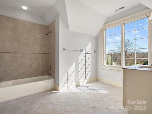 full bath featuring visible vents, baseboards, lofted ceiling, shower / tub combination, and tile patterned floors