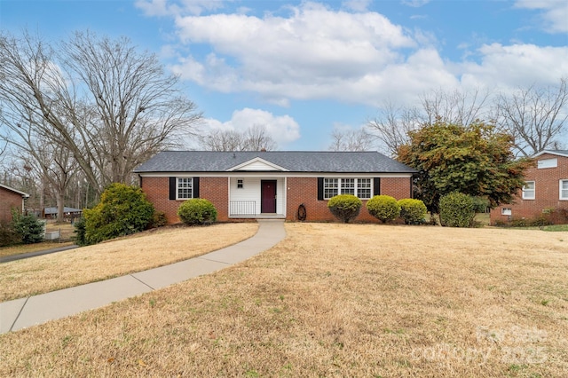 ranch-style home with a front lawn