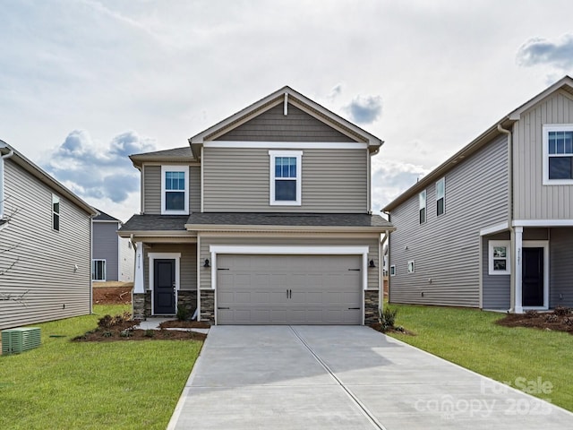 view of front of home with a garage and a front yard