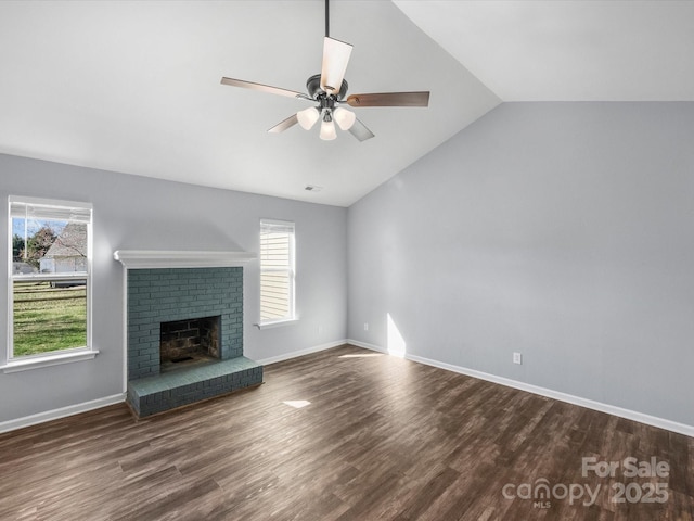 unfurnished living room with a fireplace, lofted ceiling, dark hardwood / wood-style floors, and a healthy amount of sunlight