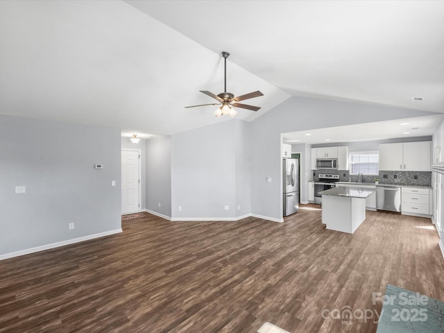 kitchen featuring white cabinetry, tasteful backsplash, stainless steel appliances, and dark hardwood / wood-style flooring