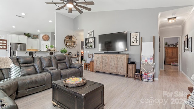 living room featuring high vaulted ceiling, ceiling fan, and light hardwood / wood-style flooring