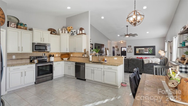 kitchen featuring appliances with stainless steel finishes, decorative light fixtures, sink, white cabinetry, and kitchen peninsula