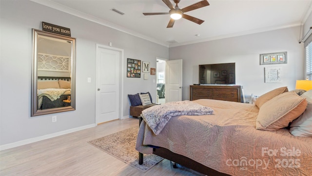 bedroom featuring ceiling fan, ornamental molding, and light hardwood / wood-style flooring