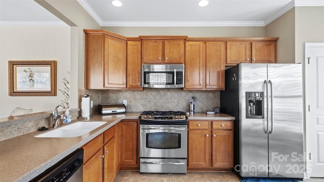 kitchen with a sink, ornamental molding, brown cabinets, stainless steel appliances, and backsplash