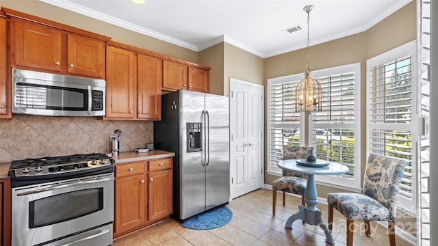 kitchen with brown cabinets, visible vents, a notable chandelier, and stainless steel appliances
