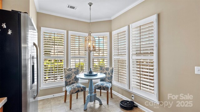 dining area with visible vents, baseboards, light tile patterned floors, ornamental molding, and a chandelier