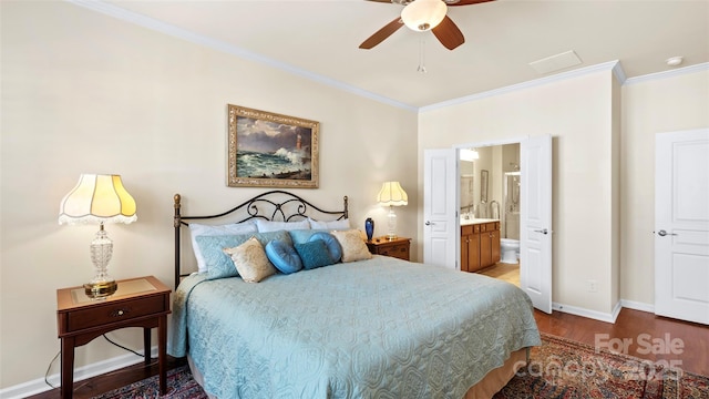 bedroom with ensuite bath, baseboards, ornamental molding, and wood finished floors