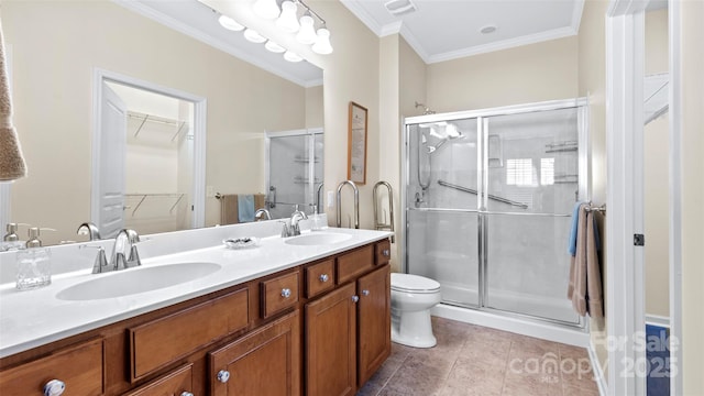 bathroom with a stall shower, a sink, and tile patterned floors