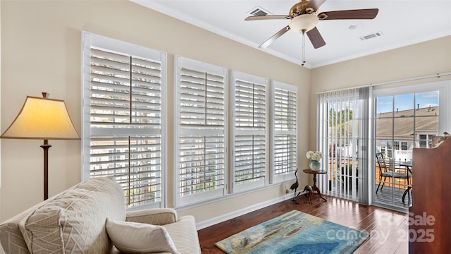 living area with ceiling fan, visible vents, baseboards, and wood finished floors