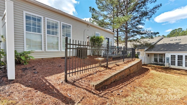 view of yard featuring central air condition unit and fence