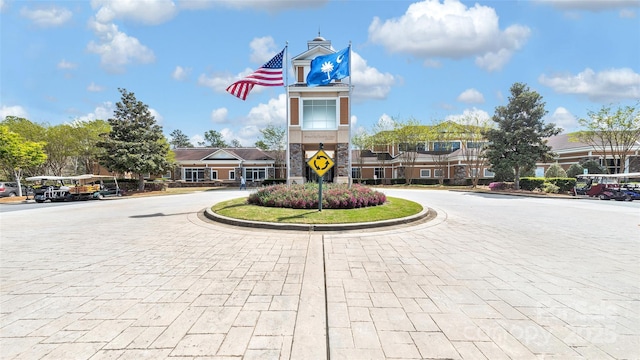 view of property featuring curved driveway