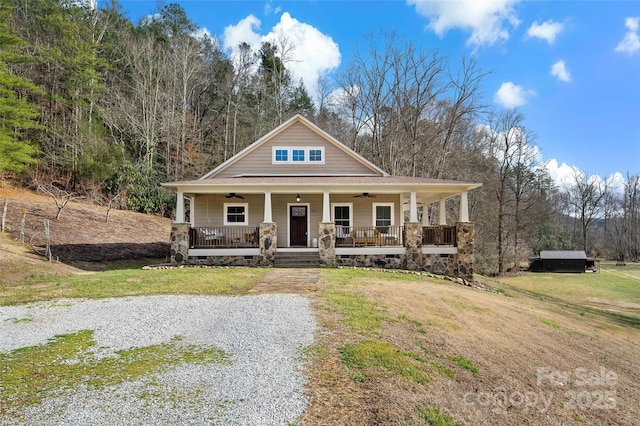 view of front of home with covered porch and a front lawn