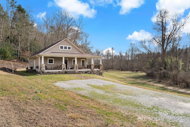 view of front of house with a porch and a front yard