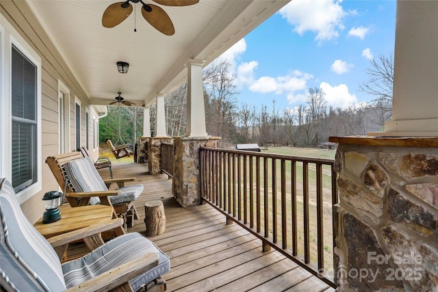 wooden deck with ceiling fan and covered porch