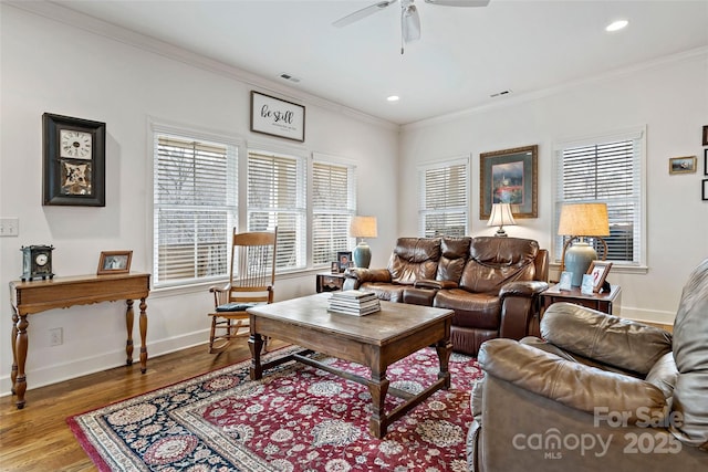 living room featuring hardwood / wood-style flooring, a wealth of natural light, and ornamental molding