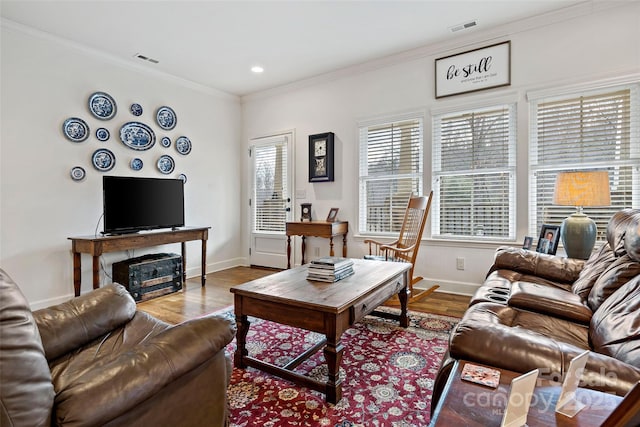 living room with hardwood / wood-style floors and ornamental molding