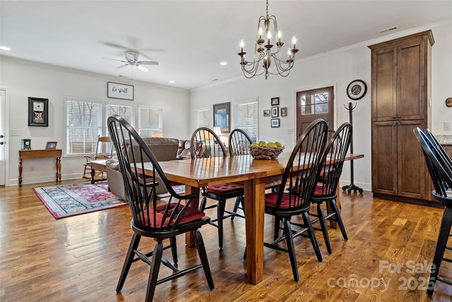 dining space featuring ornamental molding, plenty of natural light, ceiling fan, and light wood-type flooring