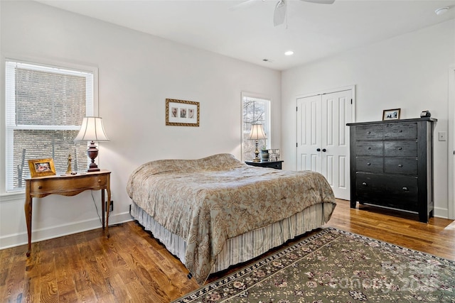 bedroom featuring hardwood / wood-style flooring, ceiling fan, and a closet