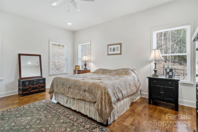 bedroom with dark wood-type flooring and ceiling fan