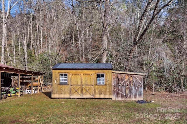 view of outbuilding featuring a lawn