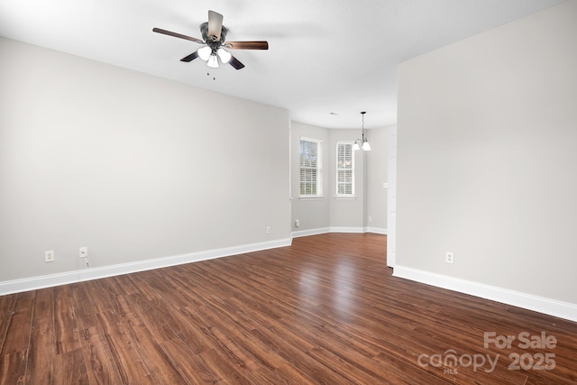 spare room with dark wood-type flooring and ceiling fan