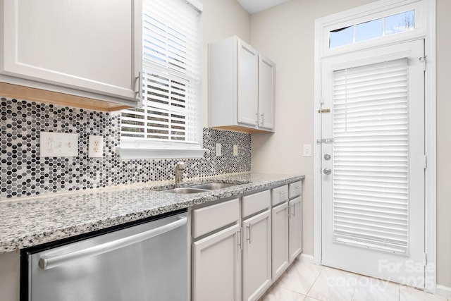 kitchen with light stone counters, dishwasher, decorative backsplash, and white cabinets