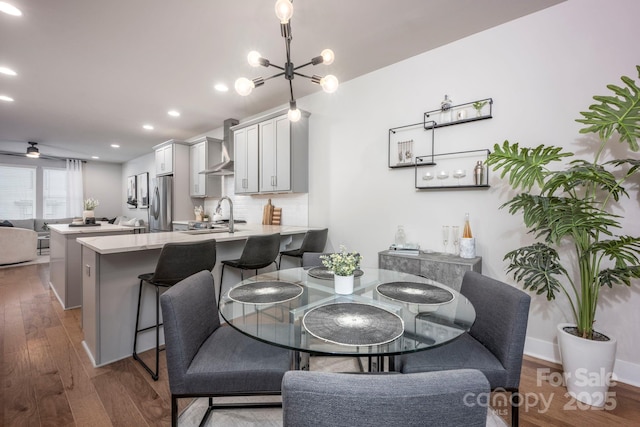 2306 Elizabeth Mill Pl, Charlotte, NC 28208 - dining room featuring baseboards, a notable chandelier, wood finished floors, and recessed lighting