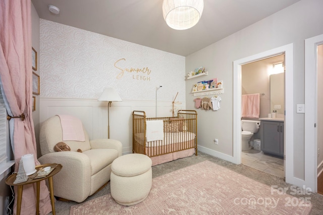 2306 Elizabeth Mill Pl, Charlotte, NC 28208 - bedroom with light colored carpet, baseboards, wallpapered walls, connected bathroom, and wainscoting