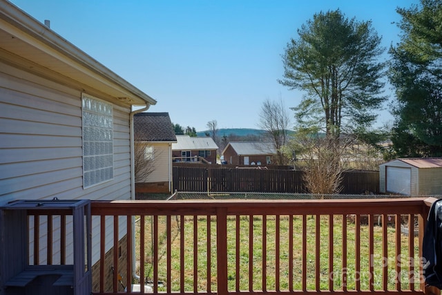 wooden deck with a shed and a yard