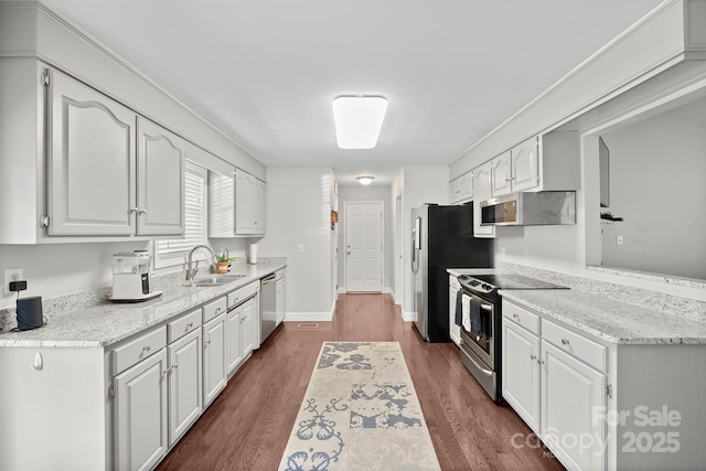 kitchen with white cabinetry, sink, light stone counters, and stainless steel appliances