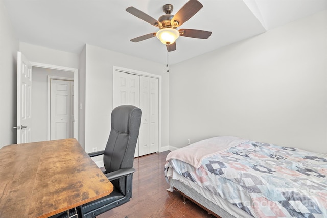 bedroom with a closet, dark hardwood / wood-style floors, and ceiling fan