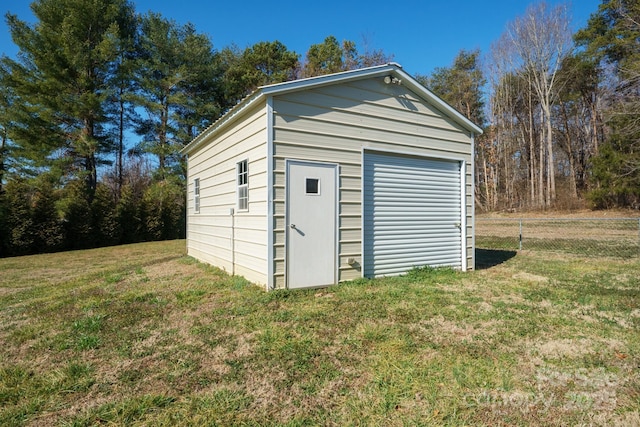 view of outbuilding with a yard and a garage