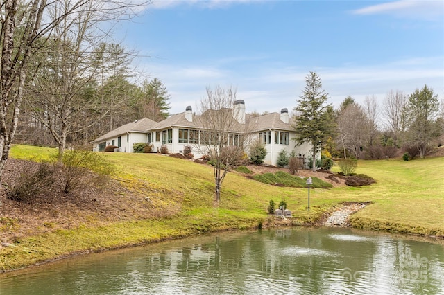 exterior space with a lawn and a water view