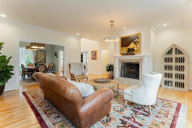 living room featuring crown molding and light wood-type flooring