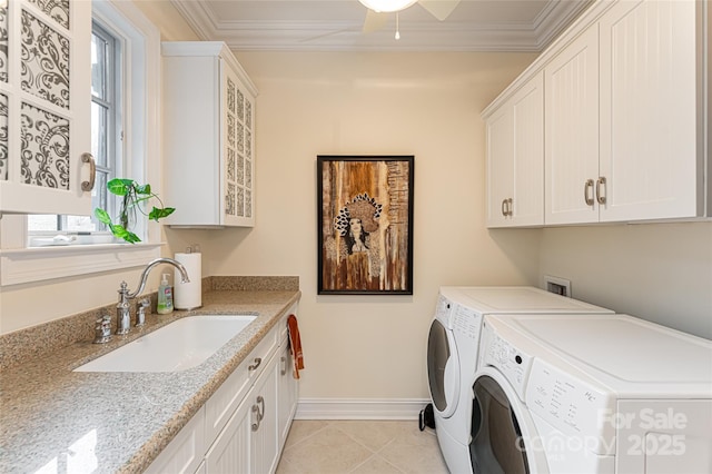 laundry room with crown molding, cabinets, sink, and washing machine and clothes dryer