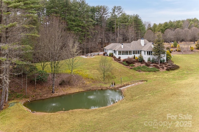 birds eye view of property with a water view