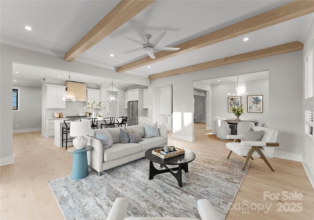 living room with baseboards, recessed lighting, beam ceiling, and light wood-style floors