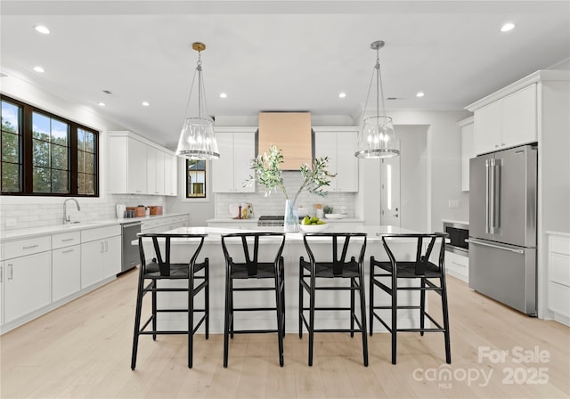 kitchen featuring appliances with stainless steel finishes, a center island, and light countertops