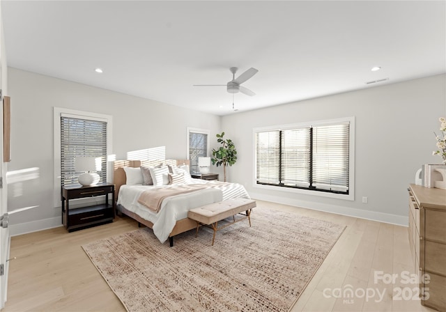 bedroom with light wood-style flooring, baseboards, and recessed lighting