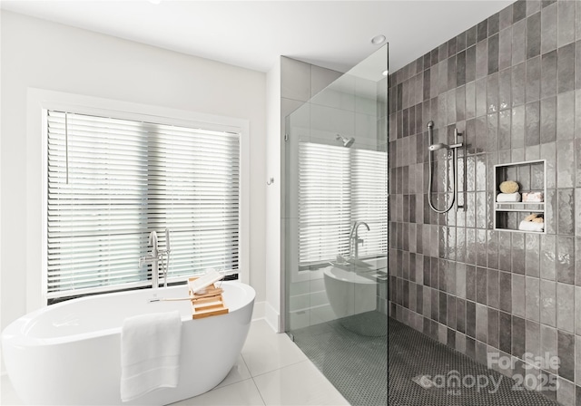 bathroom with tile patterned flooring, a walk in shower, and a freestanding bath